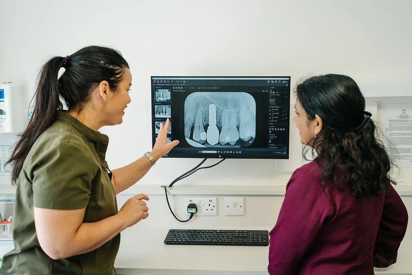Dr Clack showing a dental implant X-Ray to a patient at Toftwood Dental Practice